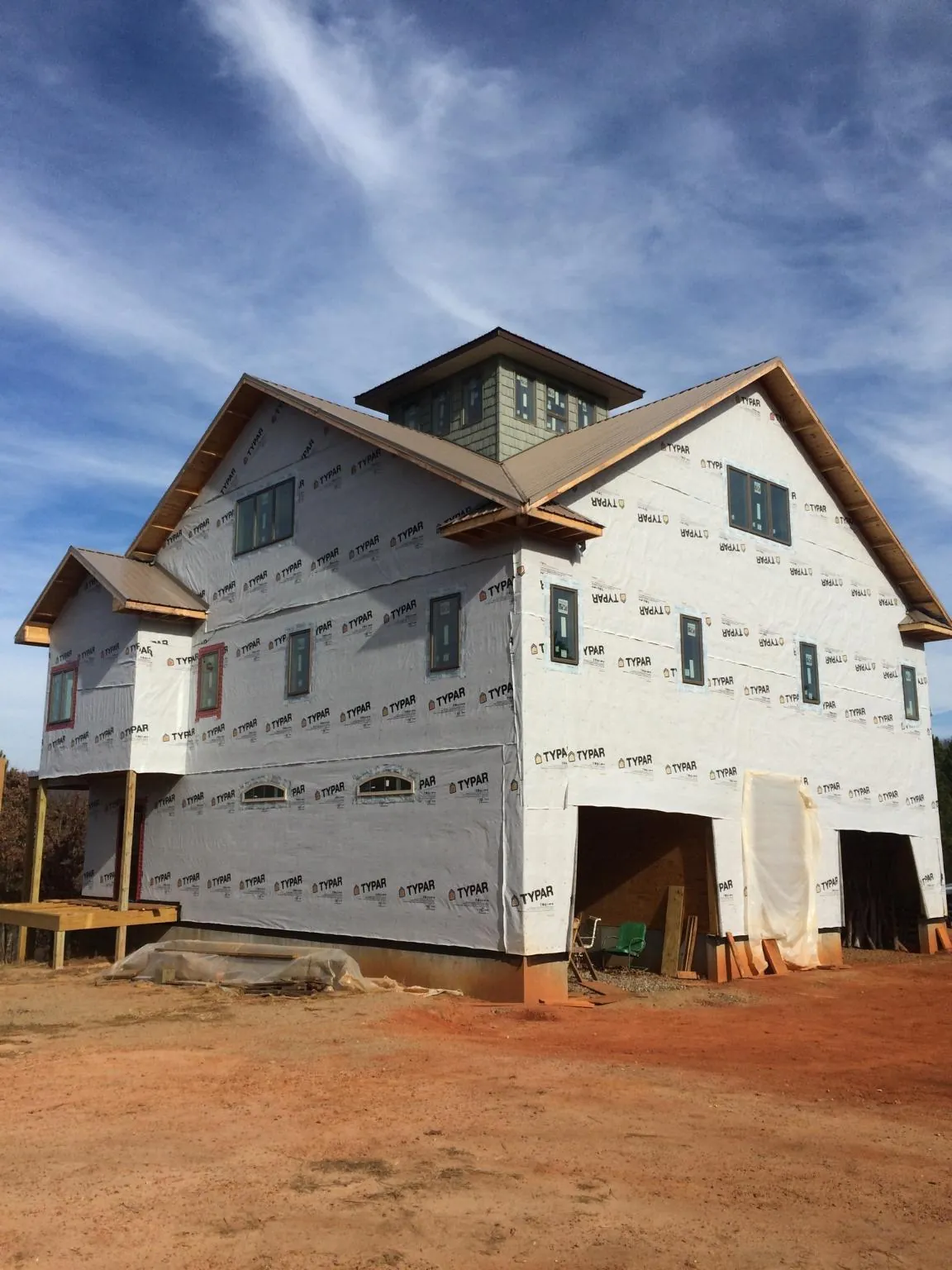 New two story house under construction with a cupola and gabled roofs in Tahuya
